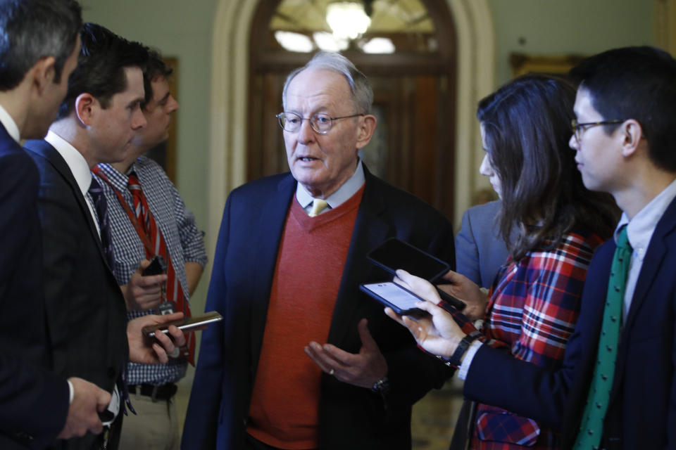 Sen. Lamar Alexander, R-Tenn., talks to reporters as he walks past the Senate chamber prior to the start of the impeachment trial of President Donald Trump at the U.S. Capitol Friday Jan 31, 2020, in Washington. Senators continue the impeachment trial for President Donald Trump. (AP Photo/Steve Helber)