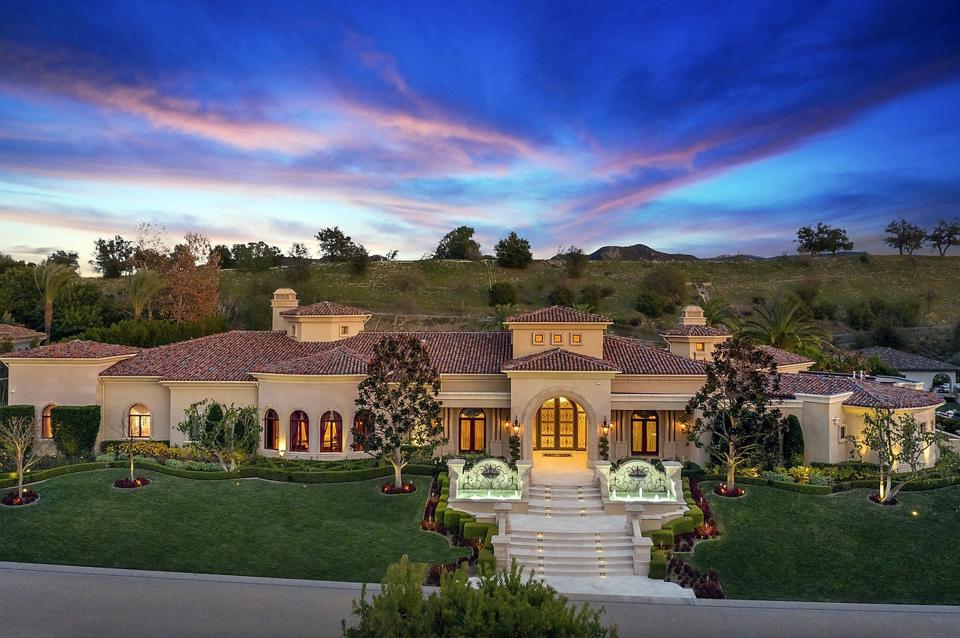 A view from outside Britney's new home, which is enormous and has fountains on either size of the walkway up to the front door