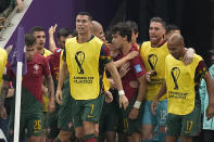 Portugal's Cristiano Ronaldo celebrates with his teammate after Portugal's Goncalo Ramos scored his side's opening goal during the World Cup round of 16 soccer match between Portugal and Switzerland, at the Lusail Stadium in Lusail, Qatar, Tuesday, Dec. 6, 2022. (AP Photo/Pavel Golovkin)