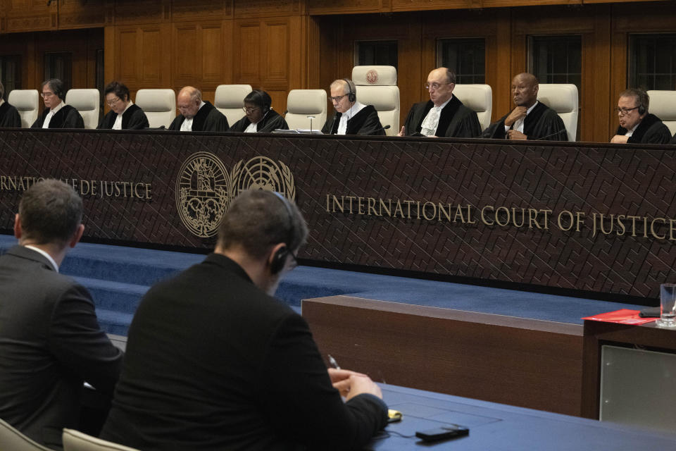 Judge Nawaf Salam, center, presides over the United Nations' highest court during historic hearings in The Hague, Netherlands, Wednesday, Feb. 21, 2024, into the legality of Israel's 57-year occupation of the West Bank and east Jerusalem, plunging the 15 international judges back into the heart of the decades-long Israeli-Palestinian conflict. Six days of hearings at the International Court of Justice, during which an unprecedented number of countries will participate in proceedings, are scheduled as Israel continues its devastating assault on Gaza. (AP Photo/Peter Dejong)