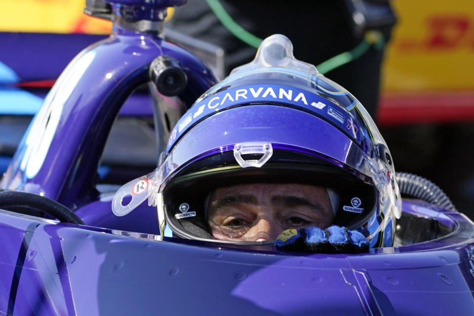 FILE - In this May 14, 2021, file photo, Jimmie Johnson climbs out of his car following practice for the IndyCar auto race at Indianapolis Motor Speedway in Indianapolis. When a pair of poor finishes cost Alex Palou the IndyCar points lead, the second-year driver found teammate Johnson for a pair of pep talks. Johnson may be an IndyCar rookie on the track, but the intangibles he brings to Chip Ganassi Racing as a seven-time NASCAR champion are invaluable. (AP Photo/Darron Cummings, File)