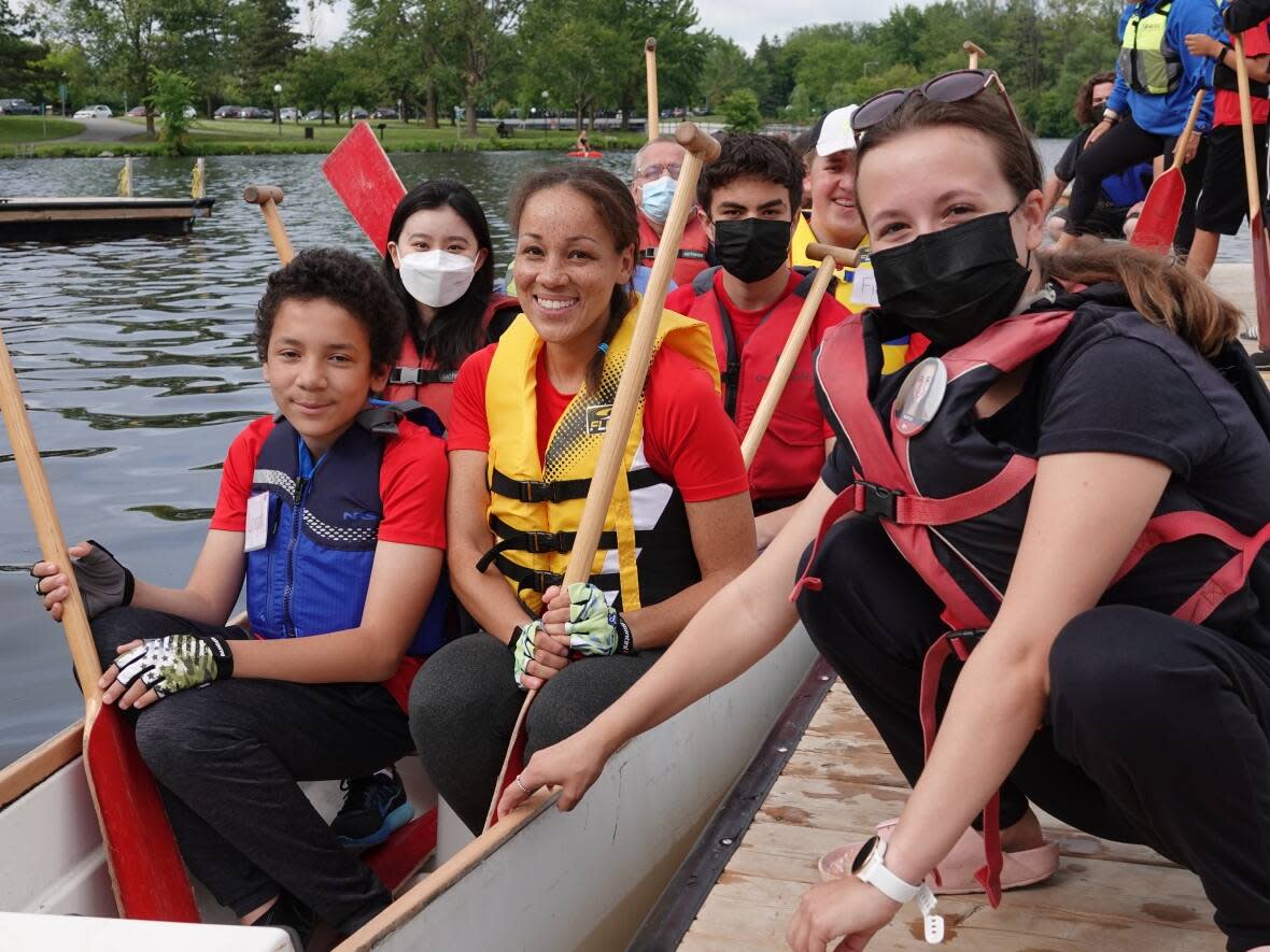 One of the boats gliding across the waves at Saturday's Ottawa Dragon Boat Festival held the team from Ausome Ottawa. it's a sports and recreation charity for kids on the autism spectrum.   (Giacomo Panico/CBC - image credit)