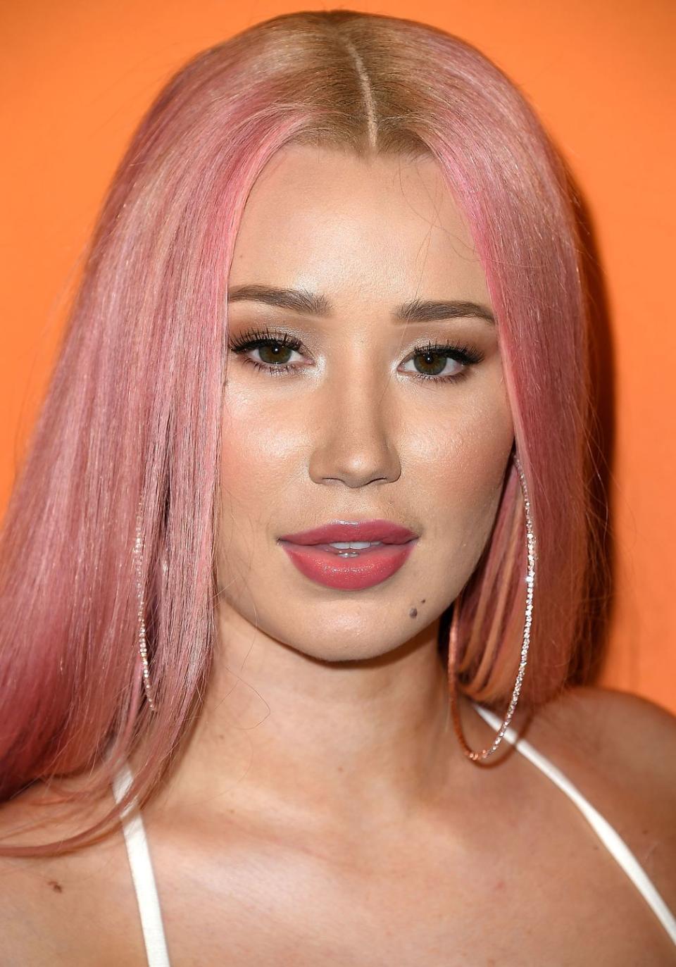 <p>Hoping for an all-over rosy shade, but want to make sure your hair maintains some dimension? Add an element of surprise to peach strands by keeping your roots a honeyed blonde, like <strong>Iggy Azalea</strong>. </p>