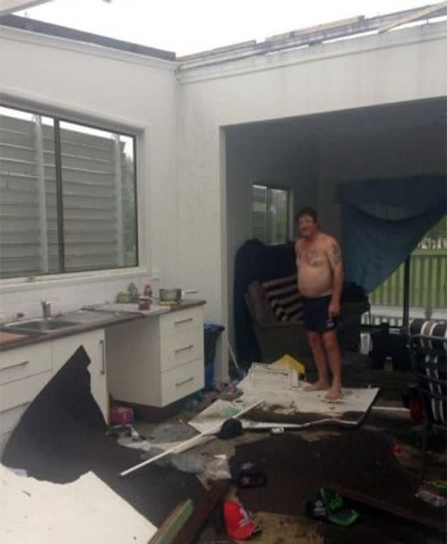 Phil Tout  inside his roofless home. Photo: Allyson Horn, ABC