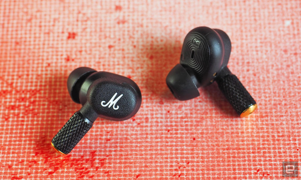 The Marshall Motif II ANC earbuds with a gridded red spray paint background.