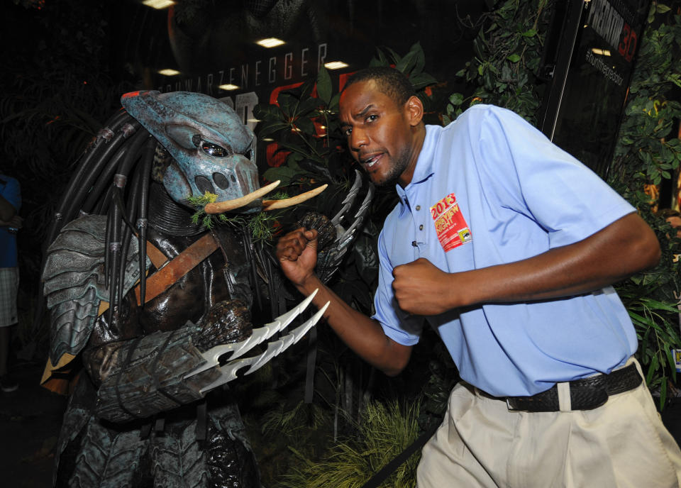 Kenneth King poses with a character from the Predator 3D movie during the Preview Night event on Day 1 of the 2013 Comic-Con International Convention on Wednesday, July 17, 2013 in San Diego. (Photo by Denis Poroy/Invision/AP)