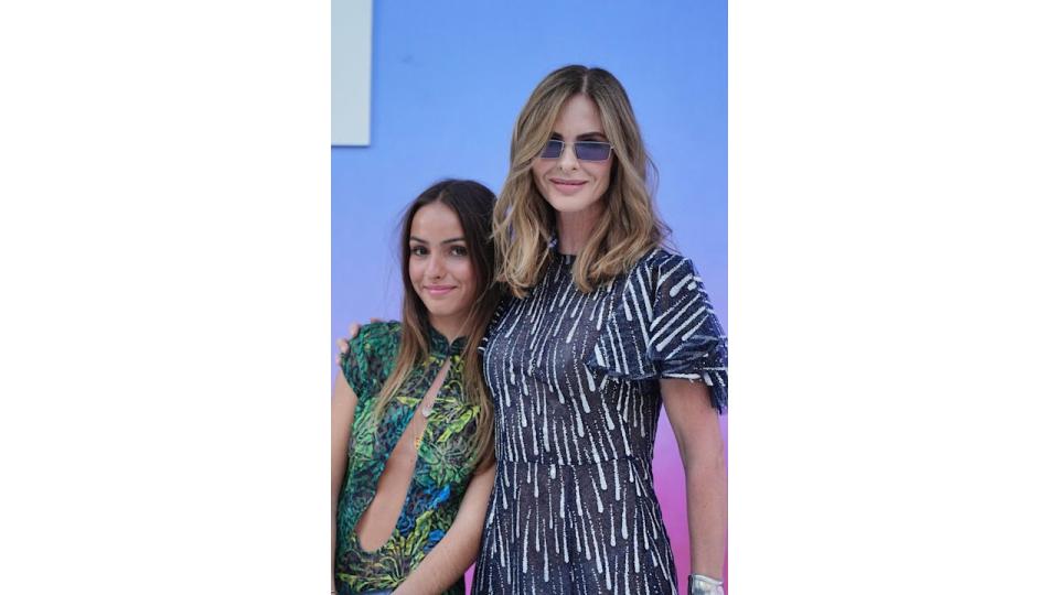 mother and daughter in smart dresses at summer party