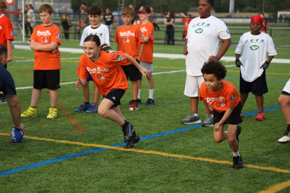 Kids take part in the Play Football Skills Camp at the Hall of Fame Village's ForeverLawn Sports Complex, Tuesday, Aug. 1, 2023, in Canton.