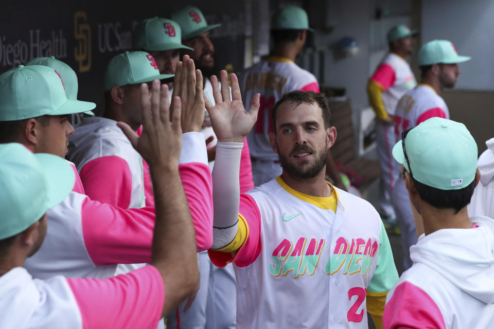 San Diego Padres' Austin Nola, second from right, is congratulated by teammates after scoring on single by Esteury Ruiz against the Arizona Diamondbacks during the second inning of a baseball game Friday, July 15, 2022, in San Diego. (AP Photo/Derrick Tuskan)