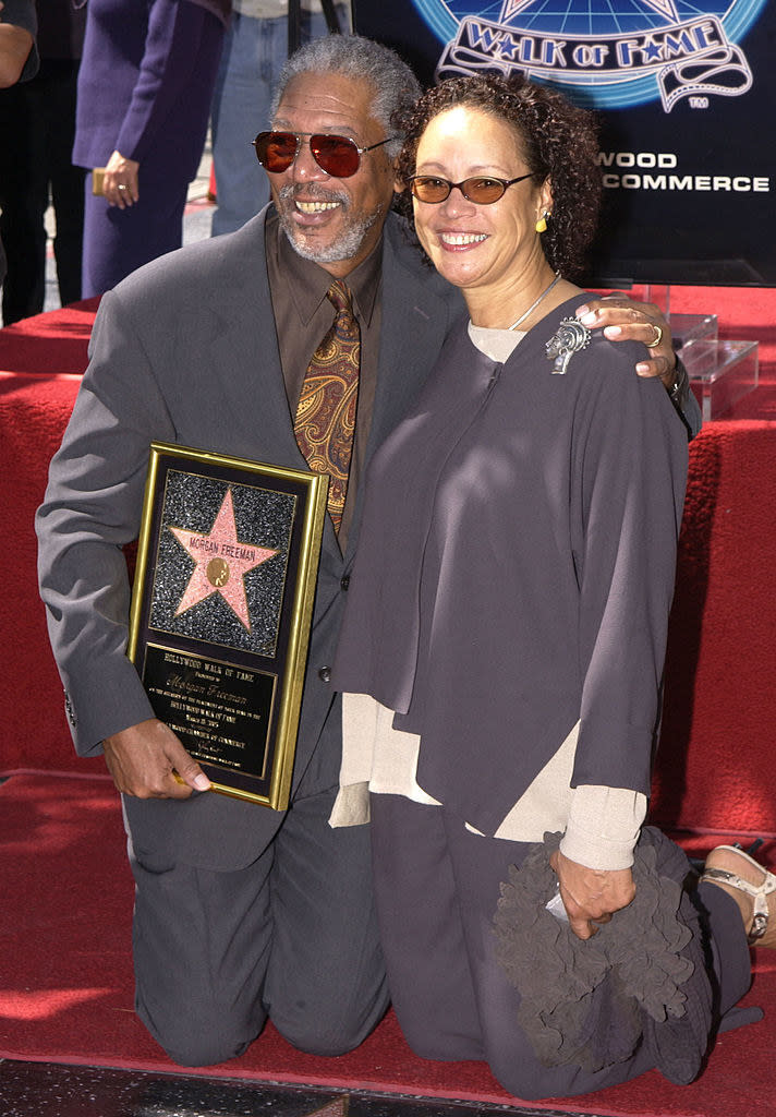 Morgan, who's holding a plaque, and Myrna kneeling at the Walk of Fame