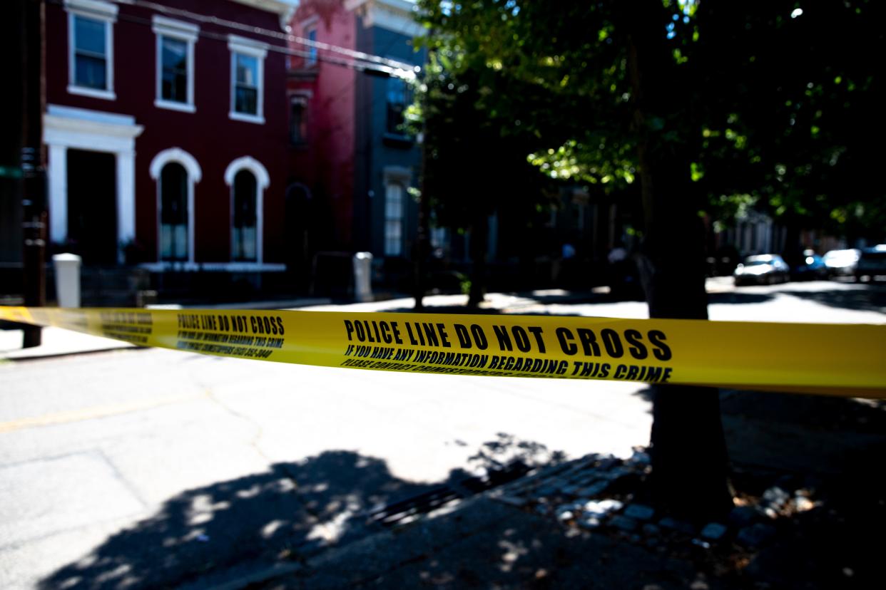 Police tape is put up while Cincinnati SWAT looks for a suspect to a fatal shooting behind the Hook Fish & Chicken restaurant in West End on Thursday, June 30, 2022. 