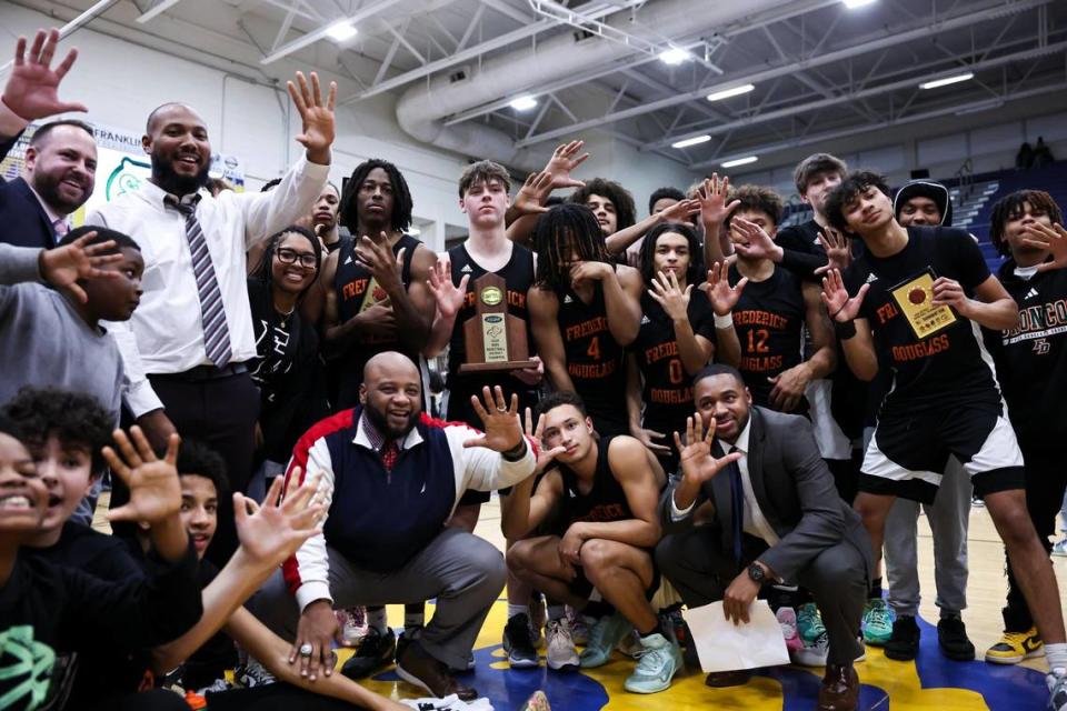 Frederick Douglass celebrates its fifth straight boys 42nd District Tournament championship after a 64-55 victory over Bryan Station in the tournament finals at Henry Clay High School on Friday.