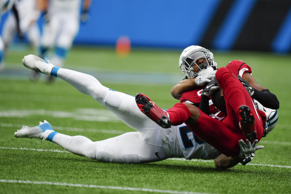 Arizona Cardinals safety Jalen Thompson is tackled by Carolina Panthers wide receiver DJ Moore after an interception during the first half of an NFL football game on Sunday, Oct. 2, 2022, in Charlotte, N.C. (AP Photo/Jacob Kupferman)