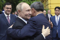 Russian President Vladimir Putin, left, and Vietnamese President To Lam embrace during an official welcome ceremony at the Presidential Palace, in Hanoi, Thursday, June 20, 2024. (Gavriil Grigorov, Sputnik, Kremlin Pool Photo via AP)