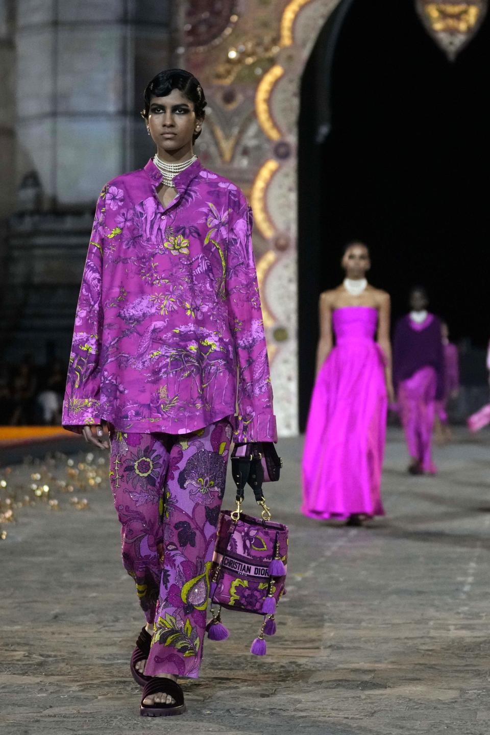 A model wears a creation for the Dior Pre-Fall 2023 collection at the Gateway of India landmark monument in Mumbai, India, Thursday, March 30, 2023. (AP Photo/Rafiq Maqbool)