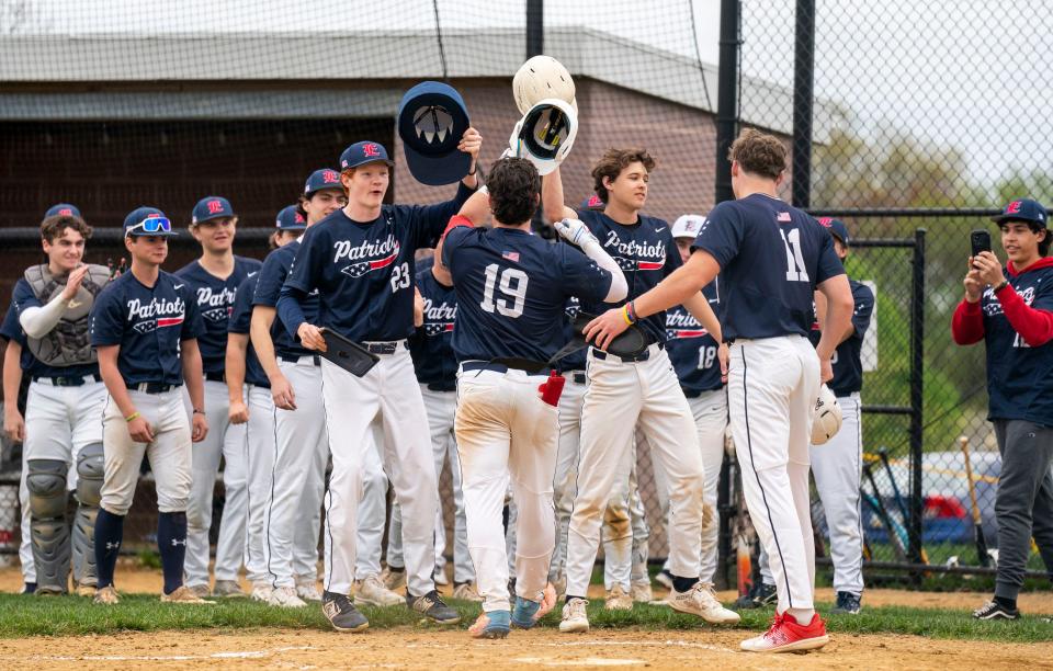 Central Bucks East's Jack Mislan (19) celebrates scoring against Harry S. Truman with teammates Damian Frayne (23), Chase Harlan (11), Nolan Behm (7), and others during an April 19 game in Levittown.