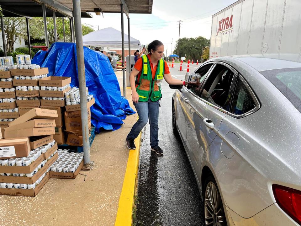 Volunteers with the Community Emergency Response Team hand out water and meals ready to eat to residents of Jefferson County.