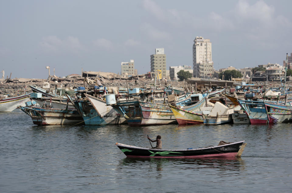 In this Friday Sept. 28, 2018 photo, a fisherman paddles his boat past destroyed buildings on the coast of the port city of Hodeida, Yemen. With US backing, the United Arab Emirates and its Yemeni allies have restarted their all-out assault on Yemen’s port city of Hodeida, aiming to wrest it from rebel hands. Victory here could be a turning point in the 3-year-old civil war, but it could also push the country into outright famine. Already, the fighting has been a catastrophe for civilians on the Red Sea coast. (AP Photo/Hani Mohammed)