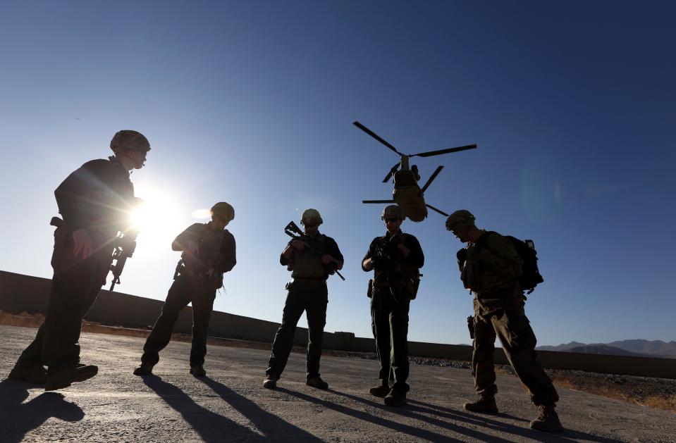 FILE - In this Nov. 30, 2017 file photo, American soldiers wait on the tarmac in Logar province, Afghanistan. Top officials in the White House were aware in early 2019 of classified intelligence indicating Russia was secretly offering bounties to the Taliban for the deaths of Americans, a full year earlier than has been previously reported.  (AP Photo/Rahmat Gul, File)