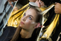 A model gets her hair done backstage at the Diesel Black Gold Spring 2013 show during Fashion Week in New York on Tuesday, Sept. 11, 2012. (Photo by Charles Sykes/Invision/AP)