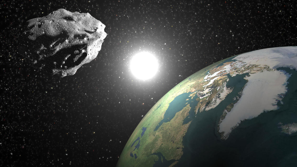  An illustration of an asteroid orbiting the sun alongside Earth, much like the newly classified quasi-moon 