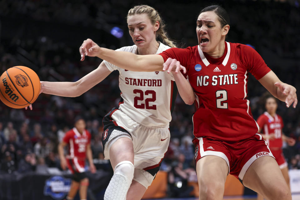 Stanford forward Cameron Brink (22) and North Carolina State forward Mimi Collins (2) go for the ball during the second half of a Sweet 16 college basketball game in the women's NCAA Tournament, Friday, March 29, 2024, in Portland, Ore. (AP Photo/Howard Lao)