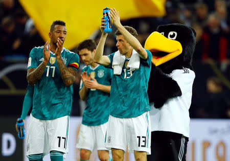 Soccer Football - International Friendly - Germany vs Spain - ESPRIT arena, Dusseldorf, Germany - March 23, 2018 Germany’s Jerome Boateng and Thomas Mueller applaud their fans after the match REUTERS/Thilo Schmuelgen