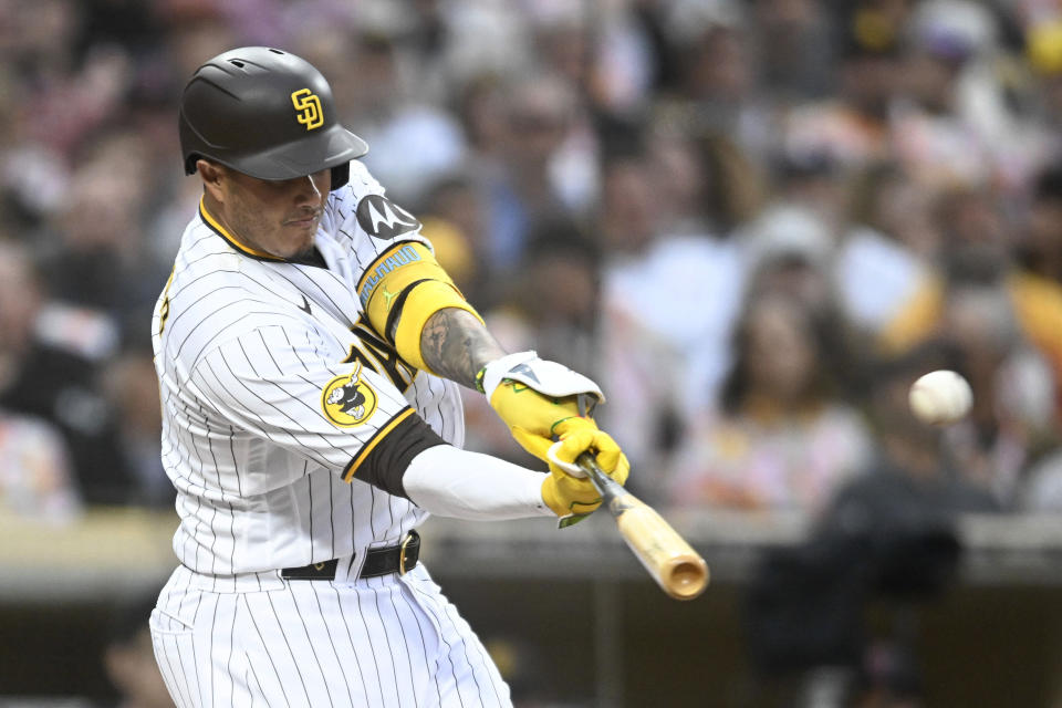 San Diego Padres' Manny Machado hits a solo home run against the Cleveland Guardians during the third inning of a baseball game Wednesday, June 14, 2023, in San Diego. (AP Photo/Denis Poroy)