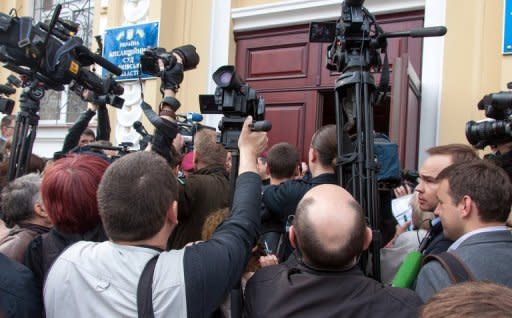 Journalists vie to get into a court building in Kharkiv prior to the trial opening of jailed opposition leader Yulia Tymoshenko on Thursday. A Ukrainian court opened new criminal hearings against Tymoshenko in a case set to further dent the ex-Soviet nation's EU membership hopes