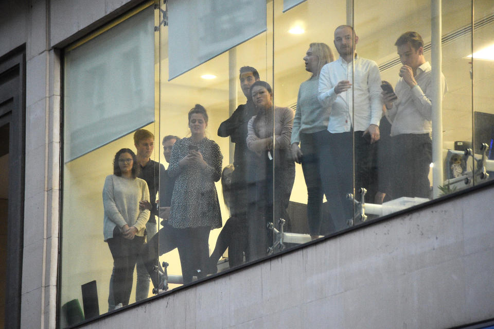 Office workers watching police near the scene of an incident on London Bridge in central London.