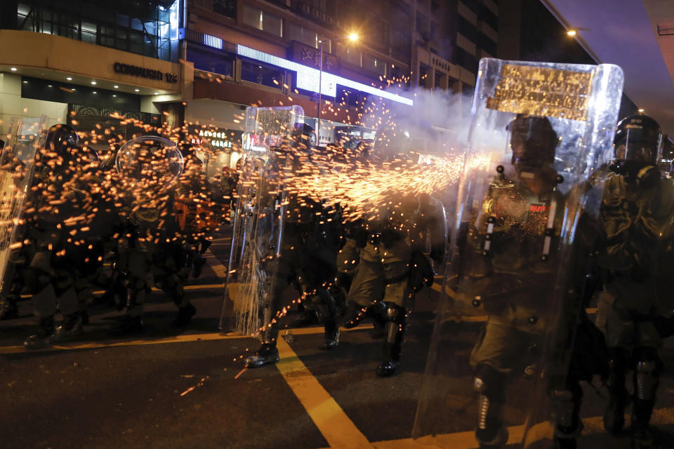 Riot police fire tear gas at protesters during a protest against police brutality at Sai Wan district in Hong Kong, Sunday, July 28, 2019. Police fired tear gas at protesters in Hong Kong on Sunday for the second night in a row in another escalation of weeks-long pro-democracy protests in the semi-autonomous Chinese territory. (AP Photo/Vincent Yu)