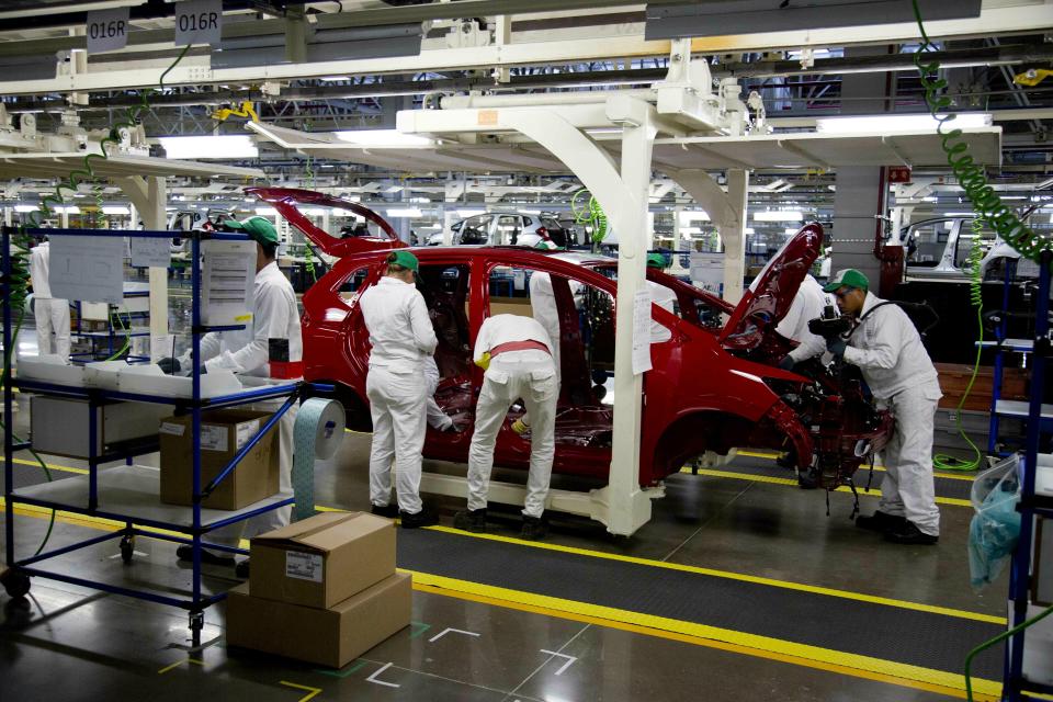 FILE- In this Feb. 21, 2014, file photo employees work in a Honda car plant in Celaya, in the central Mexican state of Guanajuato. Backing away from his vow to close America’s southern border, President Donald Trump on Thursday, April 4, 2019, and Friday promised instead that he’d slap tariffs on cars imported from Mexico if the illegal flow of people and narcotics doesn’t stop. (AP Photo/Eduardo Verdugo, File)