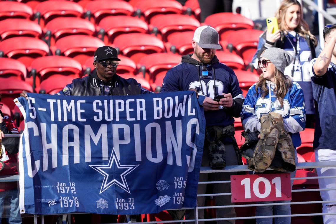 Fans watch players warm up before an NFL divisional round playoff football game between the San Francisco 49ers and the Dallas Cowboys in Santa Clara, Calif., Sunday, Jan. 22, 2023. (AP Photo/Tony Avelar)