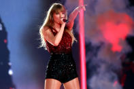 <p>As Swift moved on to other songs on her <em>Red</em> album, including "I Knew You Were Trouble," she took off her "22" inspired shirt and hat to reveal a sequin Ashish romper in red and black. </p>