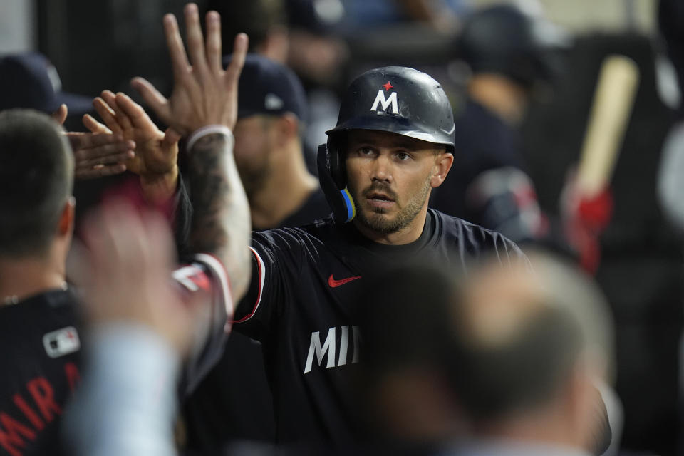 Minnesota Twins designated hitter Trevor Larnach celebrates with teammates in the dugout after scoring on a triple from Twins' Willi Castro during the fifth inning of a baseball game against the Chicago White Sox, Tuesday, April 30, 2024, in Chicago. (AP Photo/Erin Hooley)