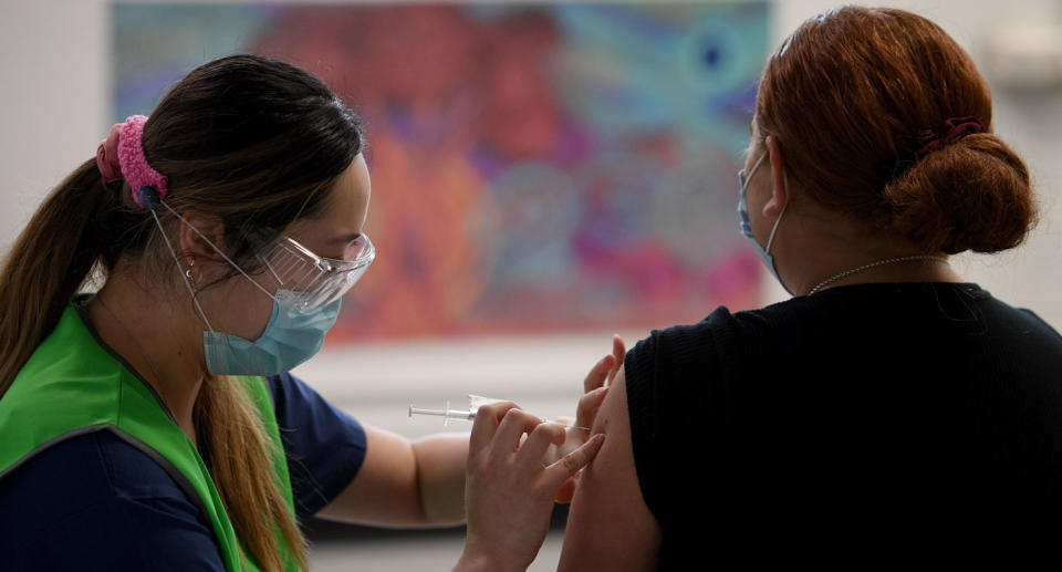 A member of the community is seen receiving a Covid vaccine at the Kimberwalli Aboriginal Covid-19 vaccination Hub in Whalan, west of Sydney, Tuesday, September 28, 2021. Source: AAP