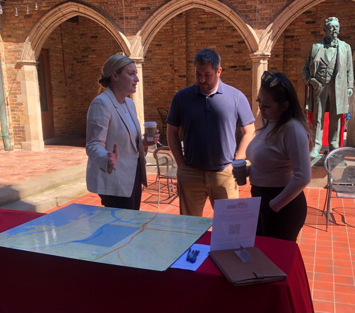 Audrey Gibson-Cicchino, RNC Coordinator for the US Secret Service, left, speaks to Kyle Vinson, center, and Shoua Thao of 3L Real Estate, about what they can expect for their properties within the impact zone. The RNC is scheduled to take place in July.