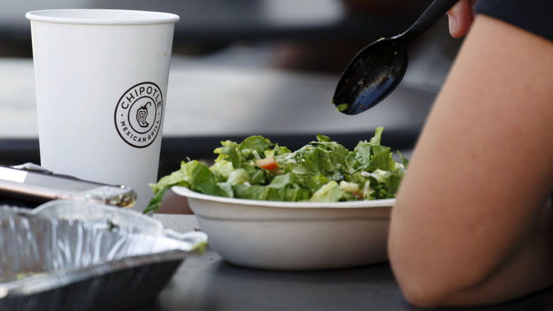 person eating Chipotle at table