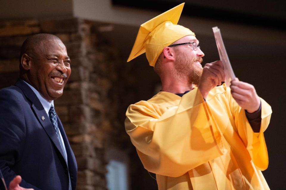 Graduate Wesley Haskins shows off his diploma during the 2023 Jackson Day Reporting Center Graduation inside Englewood Baptist Church on Tuesday, Mar. 21, 2023. 