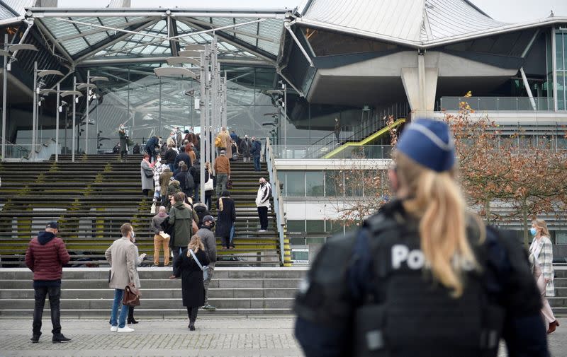 People wait to enter the court building in Antwerp