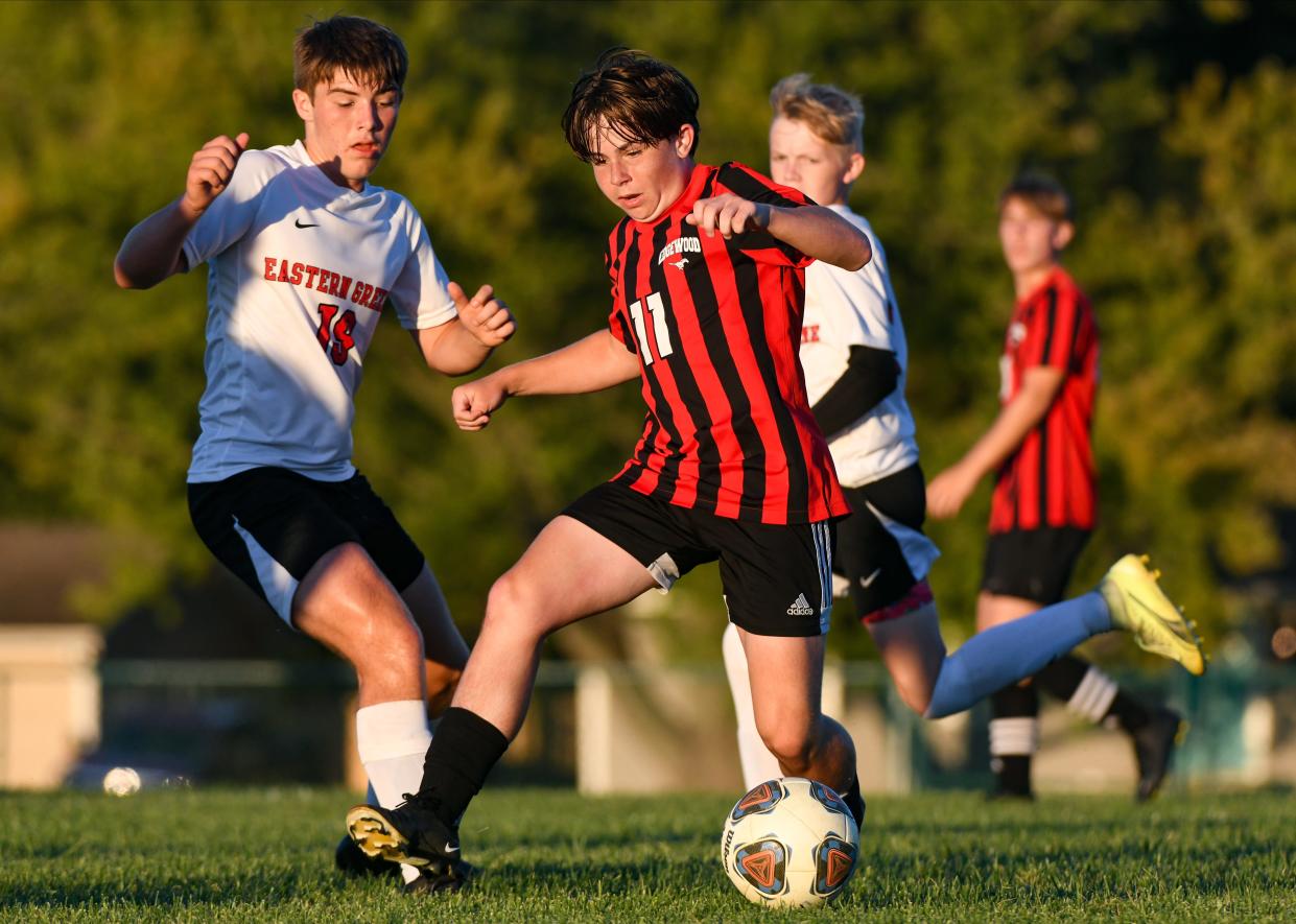 Edgewood’s Kade Gilchrist (11) dribbles across the field against Eastern Greene’s Roman Valentine (19) during their soccer match at Edgewood on Thursday, August 31, 2023.
