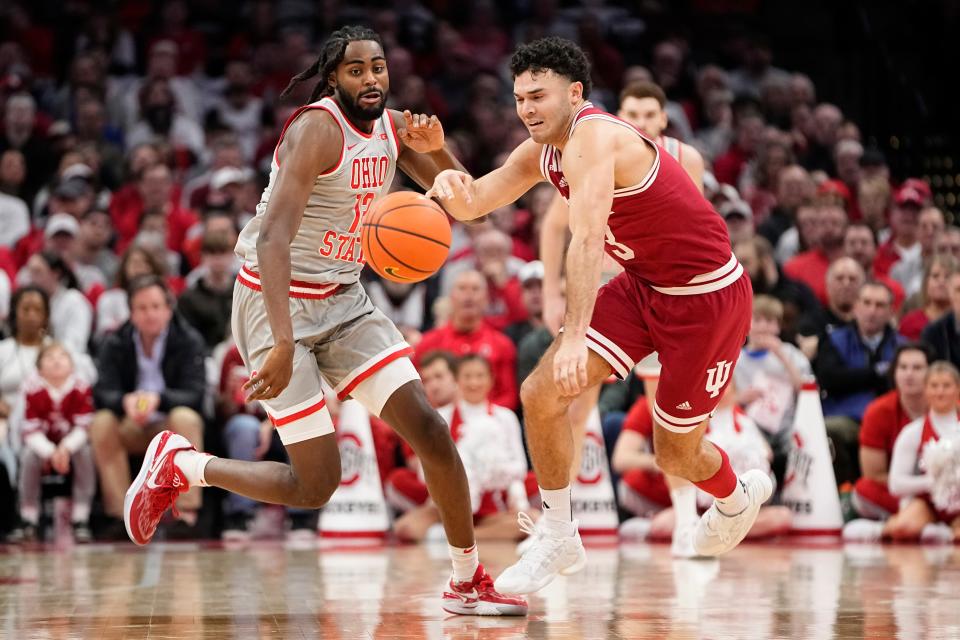 Feb 6, 2024; Columbus, Ohio, USA; Ohio State Buckeyes guard Evan Mahaffey (12) races Indiana Hoosiers guard Anthony Leal (3) to a loose ball during the first half of the men’s basketball game at Value City Arena.