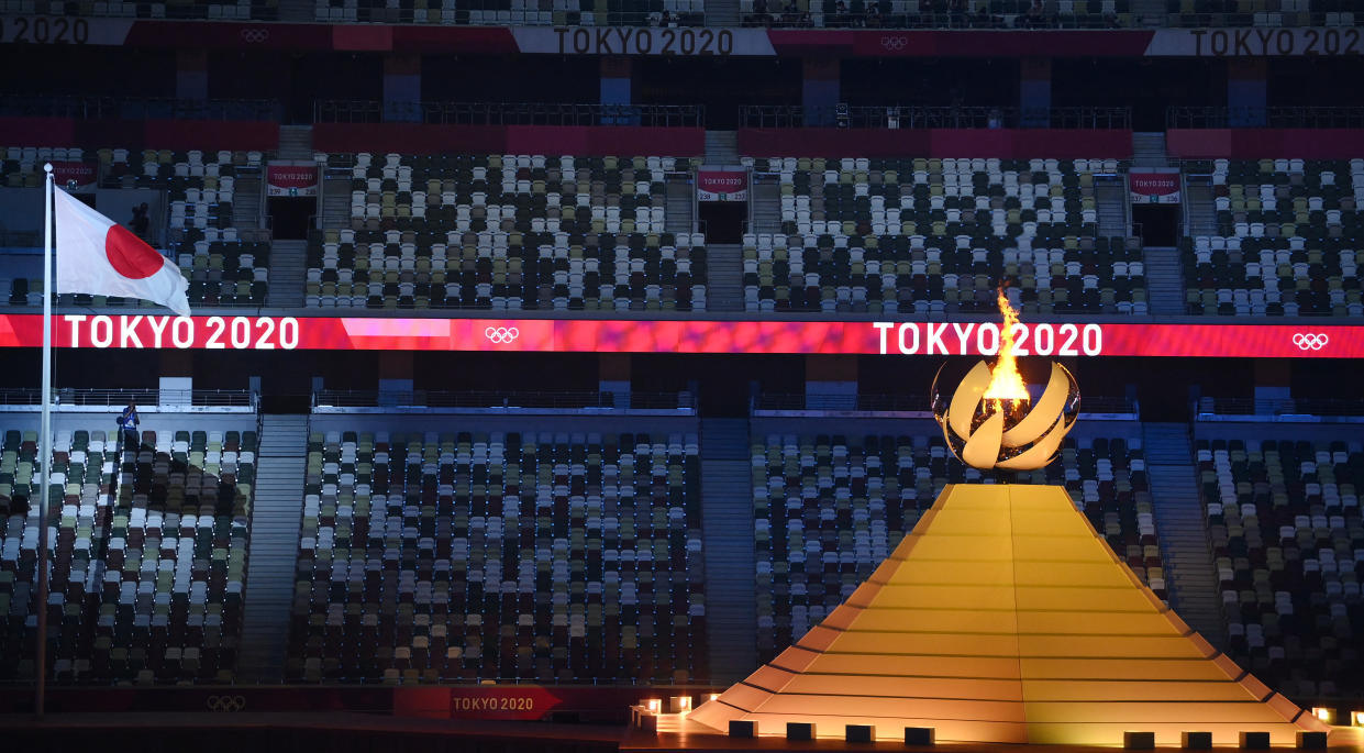 Empty seats are seen as the Olympic Flame burns after the lighting of the Olympic Cauldron during the opening ceremony of the Tokyo 2020 Olympic Games, at the Olympic Stadium, in Tokyo, on July 23, 2021. (Photo by Franck FIFE / AFP) (Photo by FRANCK FIFE/AFP via Getty Images)