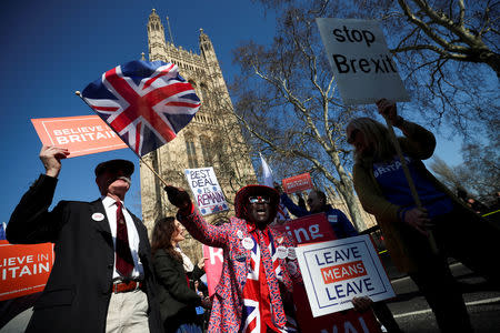 FILE PHOTO: Pro-Brexit and anti-Brexit protesters stand outside of the Houses of Parliament in London, Britain, February 27, 2019. REUTERS/Hannah Mckay/File Photo