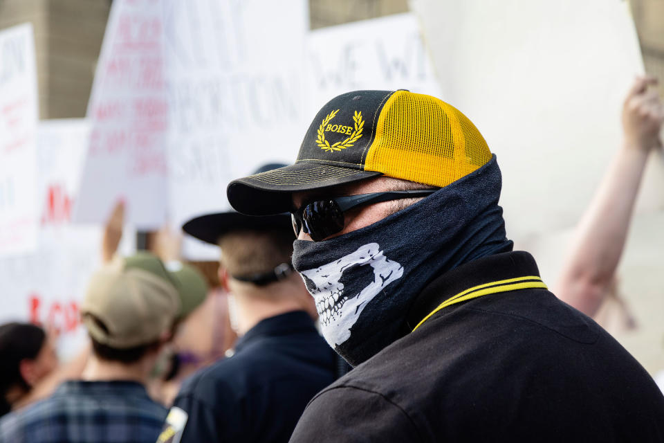 A member of the Proud Boys stands between a group of anti-abortion people attending a celebration and a group of protestors demanding the right to abortion outside of the Idaho Statehouse in Boise, Idaho on June 28, 2022.<span class="copyright">Sarah A. Miller—Idaho Statesman/AP</span>