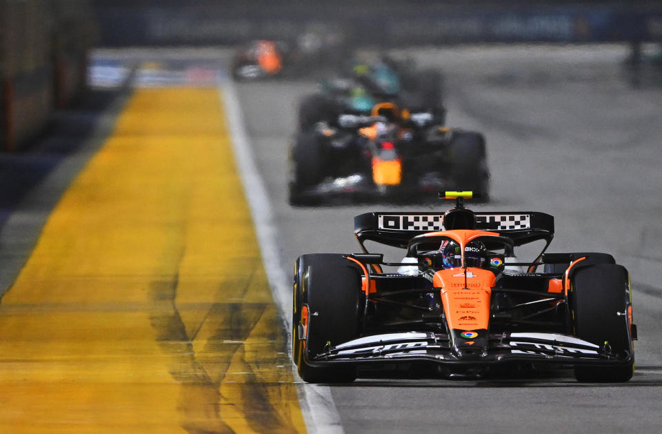 SINGAPORE, SINGAPORE - SEPTEMBER 22: Lando Norris of Great Britain driving the (4) McLaren MCL38 Mercedes leads Max Verstappen of the Netherlands driving the (1) Oracle Red Bull Racing RB20 on track during the F1 Grand Prix of Singapore at Marina Bay Street Circuit on September 22, 2024 in Singapore, Singapore. (Photo by Rudy Carezzevoli/Getty Images)