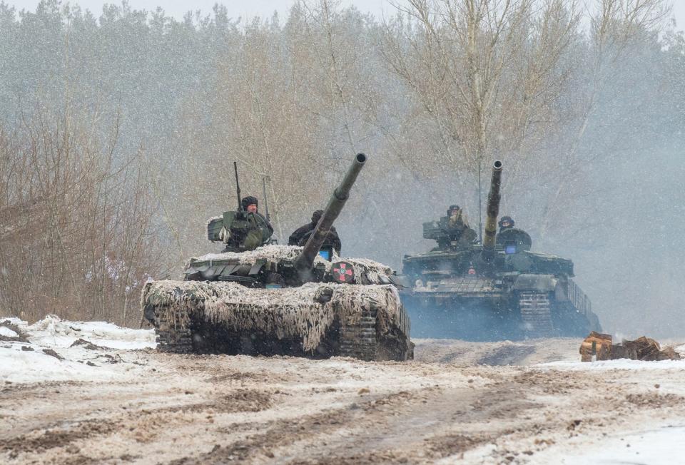 Ukrainian Military Forces servicemen of the 92nd mechanized brigade use tanks, self-propelled guns and other armored vehicles to conduct live-fire exercises near the town of Chuguev, in the Kharkiv region, on February 10, 2022. - Russia's deployment for a military exercise in Belarus and on the borders of Ukraine marks a "dangerous moment" for European security, NATO's chief said on February 10, 2022.