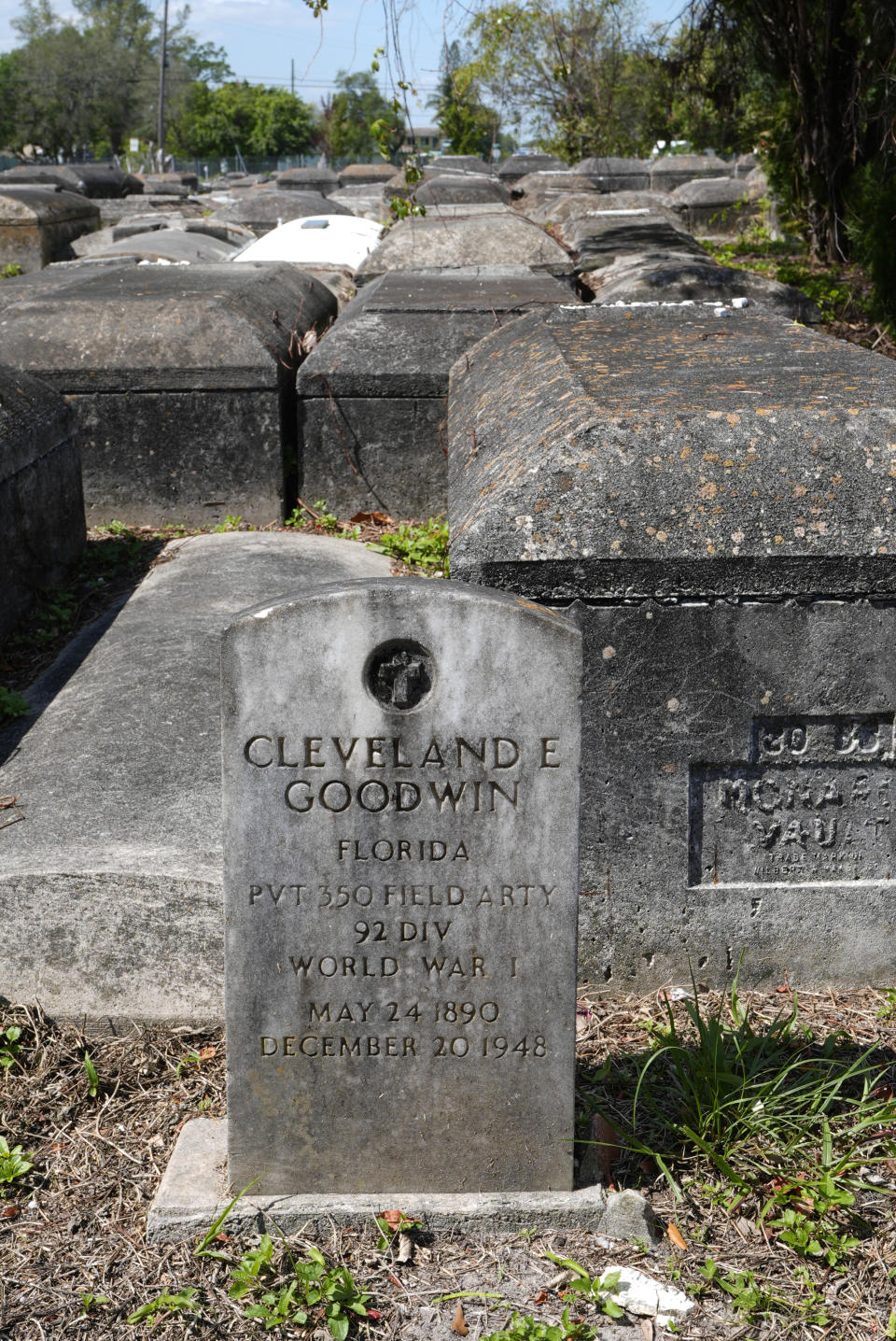 The headstone of World War I veteran Cleveland E. Goodwin stands near larger crypts at the Lincoln Memorial Park Cemetery, Monday, Feb. 26, 2024, in Miami. The cemetery holds the remains of many Black veterans from the Civil War to the Iraq War. (AP Photo/Marta Lavandier)