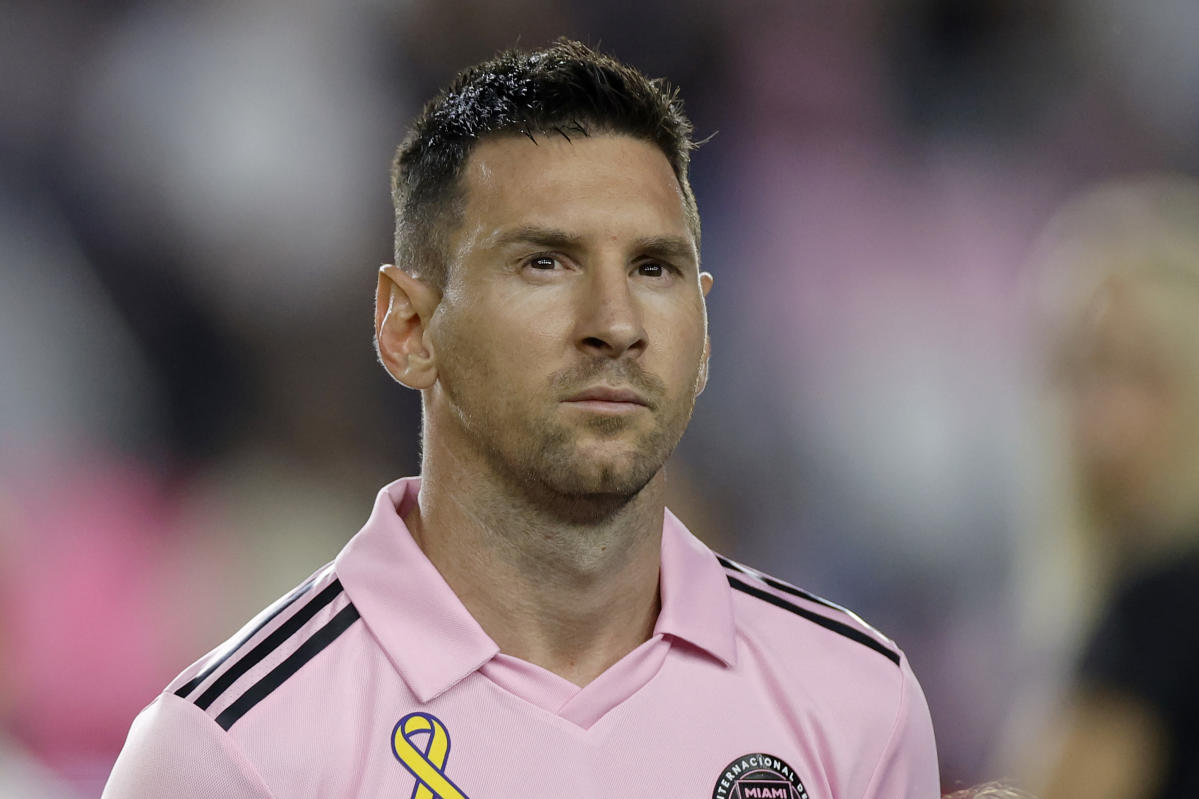 Lionel Messi of Inter Miami CF poses with his t-shirt during a news News  Photo - Getty Images