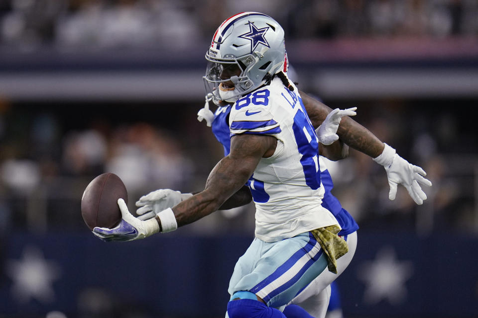 Dallas Cowboys wide receiver CeeDee Lamb (88) makes a one handed catch in front of New York Giants cornerback Deonte Banks, rear, in the first half of an NFL football game, Sunday, Nov. 12, 2023, in Arlington, Texas. (AP Photo/Julio Cortez)